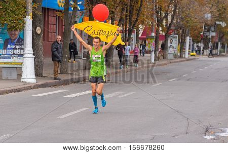 DNEPR, UKRAINE - SEPTEMBER 25, 2016:Participant as a pacemaker with red balloon that shows desired time on a 