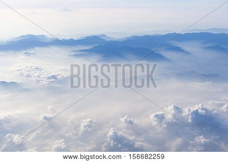 Blue sky and mountains view from airplane stylized hipster background with copyspace.