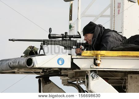 A Sniper Aims His Weapon Securing The Area As President Barack Obama