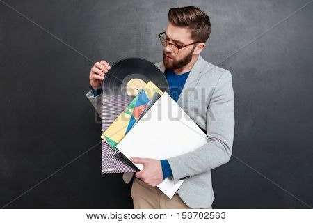 Young man with vynils. hipster. isolated black background