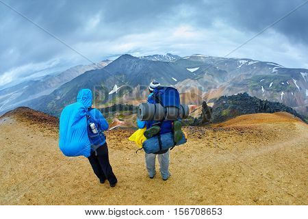 hikers on the trail in the Islandic mountains. Trek in National Park Landmannalaugar, Iceland