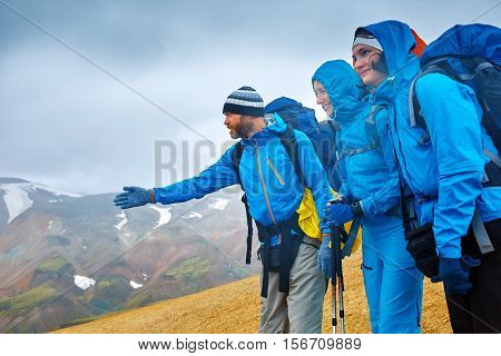 hikers on the trail in the Islandic mountains. Trek in National Park Landmannalaugar, Iceland