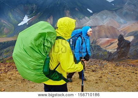 hikers on the trail in the Islandic mountains. Trek in National Park Landmannalaugar, Iceland