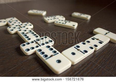 Dominoes on wooden table background. Entertainment. A game