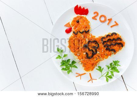 Festive salad shaped rooster or symbol of New Year 2017 on the Chinese calendar. Symbolic food at holiday dinner