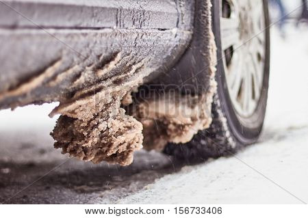 Wheels car caked with snow after a heavy snowstorm. Car covered with ice after freezing rain.