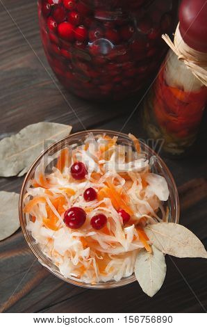 Sauerkraut with Cranberries in bowl on wood background