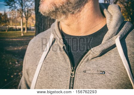 Man wearing a safety pin as a symbol of solidarity