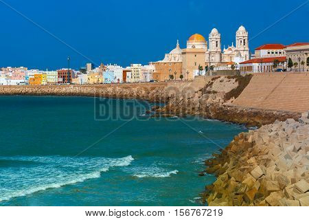 Playa de la Santamaria beach and Cathedral de Santa Cruz in the morning in Cadiz, Andalusia, Spain