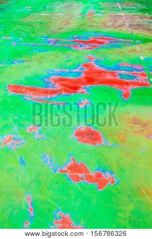 Blotchy and distressed turquoise, green and orange abstract background in vertical 3:2 format.