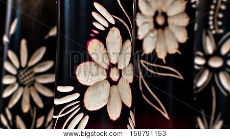 Many engraving flowers on the black wood.