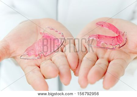 Dentist holding Retainer, Orthodontics Dental concept background