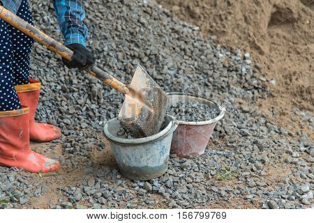 Shovel stuck in a pile of dirt,Construction worker is trying to move a kurb