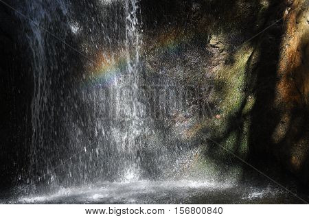 Rainbow at the waterfall Millomeris in the mountains in Cyprus