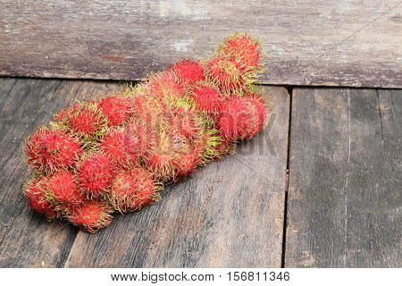 rambutan sweet fruit fresh on wood background :Select focus with shallow depth of field.