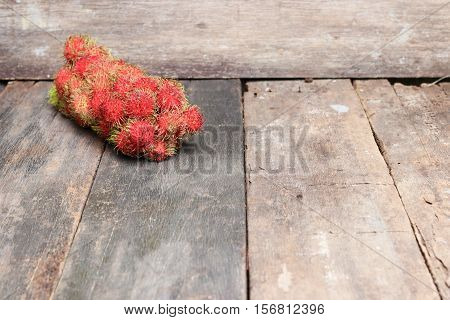 rambutan sweet fruit fresh on wood background :Select focus with shallow depth of field.