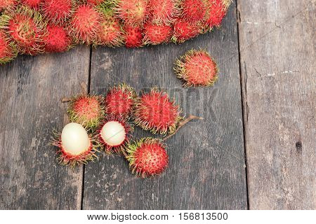 rambutan sweet fruit fresh on wood background :Select focus with shallow depth of field.