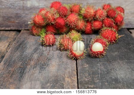 rambutan sweet fruit fresh on wood background :Select focus with shallow depth of field.