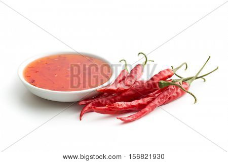Red chili peppers and chili sauce isolated on white background.
