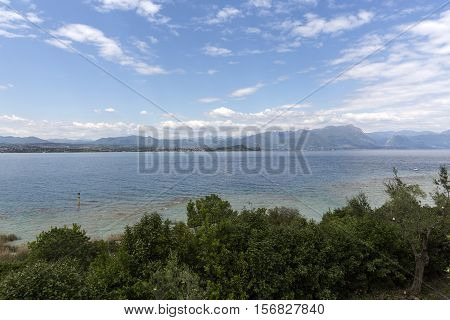 Landscape of the coast of Sirmione peninsula which divides the lower part of Lake Garda. It is a famous vacation place for a long time in northern Italy.