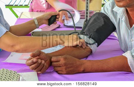 physician checking blood pressure men aged .