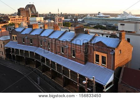Sydney Australia - October 24 2016: Aerial urban view of old buildings rooftops at the historical area The Rocks with Sydney Harbour Bridge in the background in Sydney city center Australia.