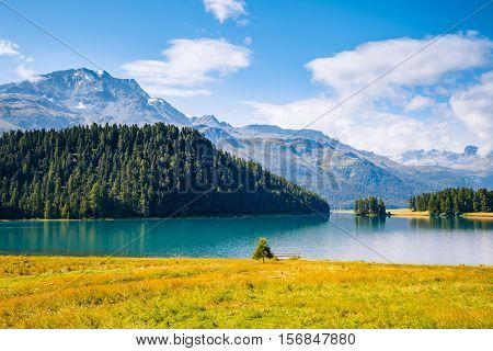 Great view of the azure pond Champfer in alpine valley. Popular tourist attraction. Picturesque and gorgeous scene. Location Swiss alps, Silvaplana village, district of Maloja, Europe. Beauty world.