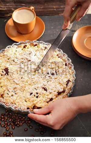 Cake with plums. Homemade pastries. Tart on flaky pastry with plums and powdered sugar