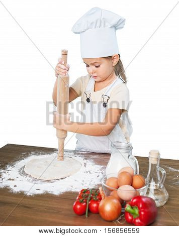 Happy little chef smeary with flour stretching the dough