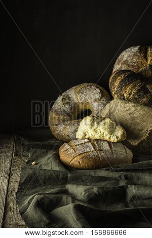 Set village breads on a green cloth with dark brown background.