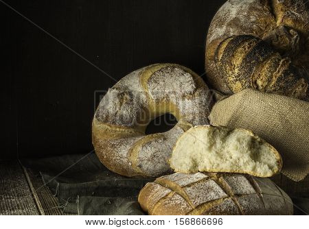 Set breads village on a green cloth with dark brown background.