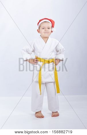 In cap of Santa Claus a little sportsman