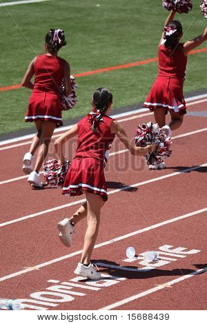 Cheerleaders running and cheering