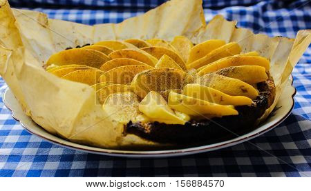 Homemade flour cake with quince and cooking utensils