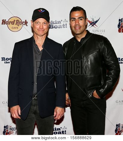 NEW YORK - MAY 21: Actor Gary Sinise (L) and J. W. Cortes attend a benefit concert at the Hard Rock Cafe on May 21, 2015 in New York City.