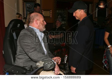 NEW YORK - MAY 21: Actor Gary Sinise (R) speaks with fans during a benefit concert at the Hard Rock Cafe on May 21, 2015 in New York City.