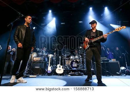 NEW YORK - MAY 21: Actors J.W. Cortes (L) and Gary Sinise perform onstage with the Lt. Dan Band at a benefit concert at the Hard Rock Cafe on May 21, 2015 in New York City.