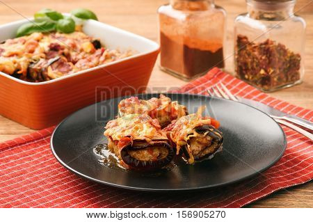 Roasted eggplants stuffed with minced meat and baked with tomatoes and cheese.