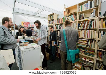 PRAGUE, CHECHIA - MAY 16, 2014: Happy students choose books at the indoor second hand market on May 16, 2014 in Czech Republic. Fourteenth-largest city in the European Union Prague is home to 1.3 million people