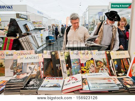 PRAGUE, CHECHIA - MAY 16, 2014: Many people choose art and photo books at the indoor book market on May 16, 2014 in Czech Republic. Fourteenth-largest city in the European Union Prague is home to 1.3 million people