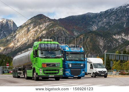 E45 Motorway, Austria - October 21, 2016: Trucks parked in a parking lot in the Alps. Trucks for various purposes and duty.