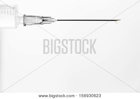 White medical syringe with a drop isolated on white background concept of medicine