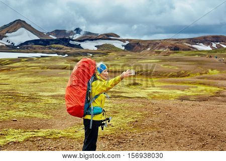 woman hiker photographer taking selfie on the rhyolite mountains background in Iceland