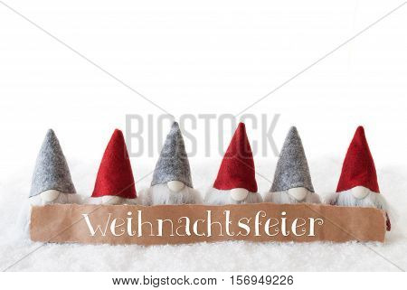 Label With German Text Weihnachtsfeier Means Christmas Party. Christmas Greeting Card With Gnomes. Isolated White Background With Snow.