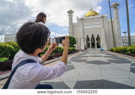 Bandar Seri Begawan,Brunei-Nov 12,2016:Tourists taking pictures with their cameras of the famous Omar Ali Saifuddien Mosque,Bandar Seri Begawan Brunei Darussalam.One of the attraction places in Brunei
