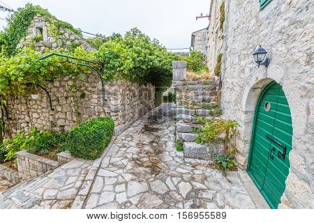 Small narrow street in Tucepi village in the slope of a mountain Biokovo.