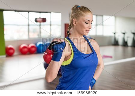 Woman Doing Heavy Weight Exercise With Kettle-bell