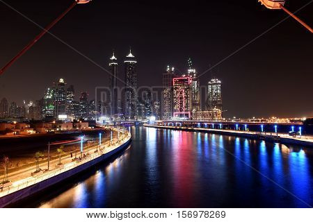 Dubai Skyline at night from new Dubai Canal, U.A.E