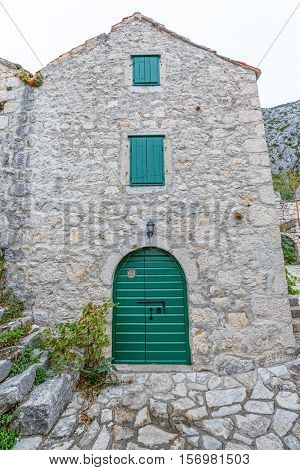 Typical house in Tucepi old village in the slope of a mountain Biokovo.
