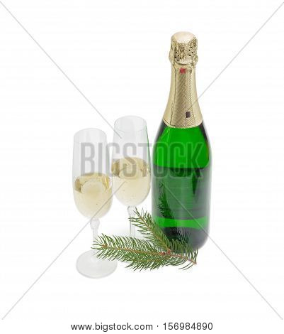 Two wine glasses with sparkling wine and a bottle of wine and fir twig on a light background